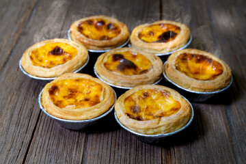 egg tart in aluminum foil cup with smoke