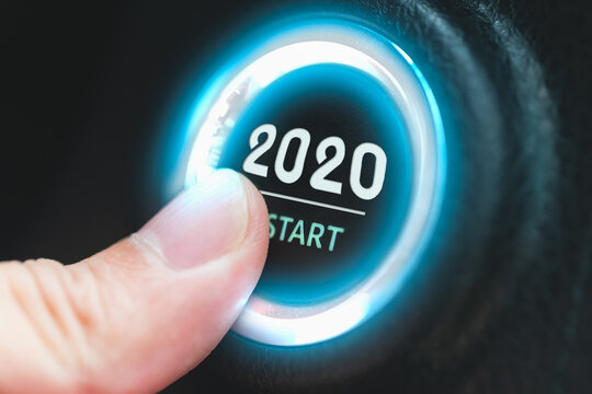 Finger pressing a 2020 start button. Concept of new year.