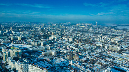 Fototapeta premium Top view of city in winter at sunset on sky background. Aerial drone photography concept. Kishinev, Republic of Moldova.