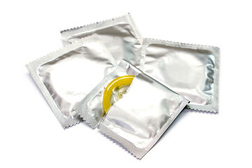 Condom in seal package and opened isolate on white background.