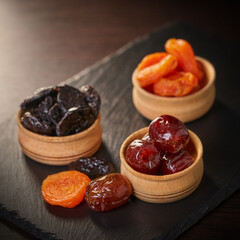 assorted dried fruits in wooden bowls