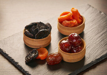 assorted dried fruits in wooden bowls