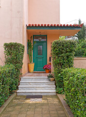 vintage house entrance green door and flowerpots, Athens Greece