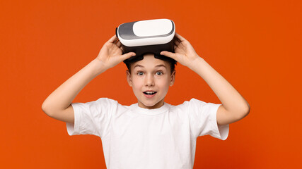 Portrait of cute teen boy in VR headset