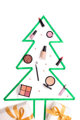 Flat lay of Christmas tree and decorative cosmetics decoration