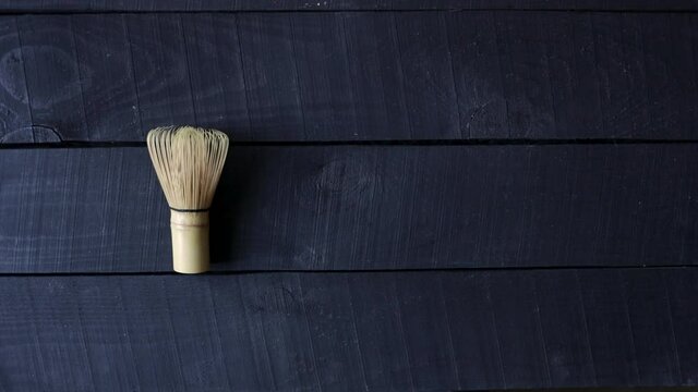 Woman put whisk and matcha tea on the table
