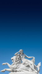 Obraz premium Old statue of sensual Renaissance Era woman laying on big lion at blue smooth background, Potsdam, Germany, details, closeup