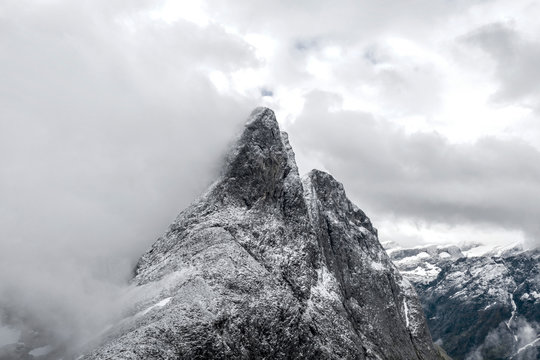 Aerial view of the rocky peak of Romsdalshornet in the mist, Venjesdalen valley, Andalsnes, More og Romsdal county, Norway