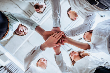 Underneath view, Business teamwork groups people hands, stacked huddle together, unity...