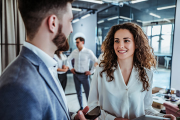 Business people having fun and chatting at workplace office