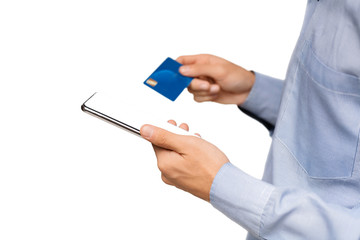 Unrecognizable man holding smartphone with blank screen and credit card.