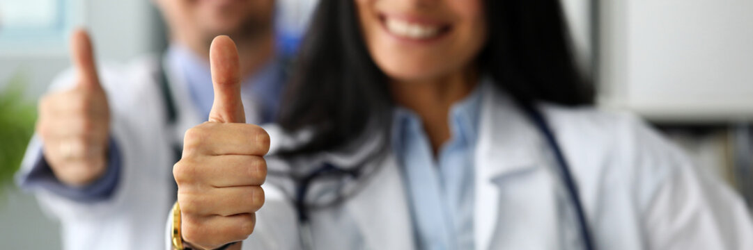 Group of doctors standing in row showing thumb up symbol