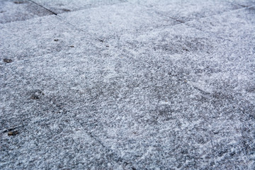 Sidewalk tiles covered with ice and snow