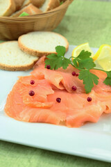 plate of smoked salmon sliced on a table