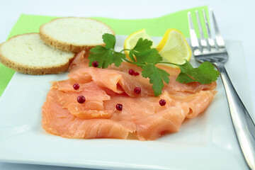 plate of smoked salmon sliced on a table
