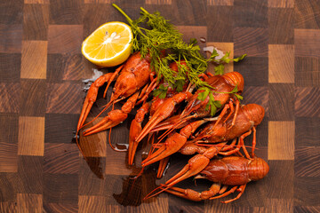 Tasty boiled crayfishes with fennel on table on sackcloth background