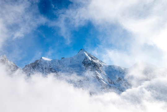 Snowcapped peak of Ober Gabelhorn in a sea of clouds,  Pennine Alps, Zinal valley, canton of Valais, Switzerland