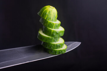 chopped cucumber on a knife edge