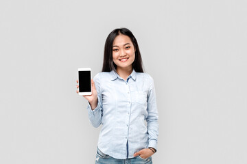 Fototapeta premium Young adult asian girl showing smartphone with copy space on display