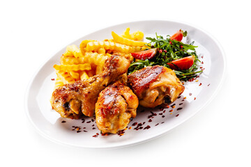 Grilled chicken drumsticks with french fries and vegetables