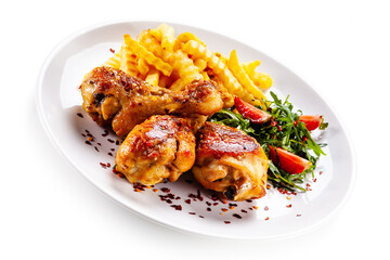 Grilled chicken drumsticks with french fries and vegetables