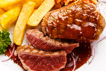 Grilled steak with french fries on white background