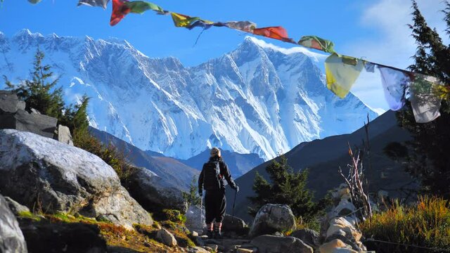 Active hiker hiking, enjoying the Mount Everest view ,  Nepal mountain range. Travel sport lifestyle concept