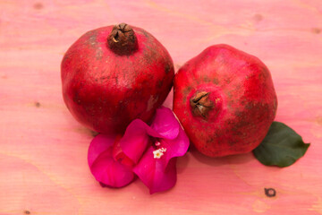 red pomegranate fruit on pink background