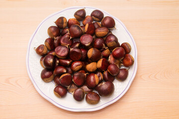 plate full of chestnuts on wood