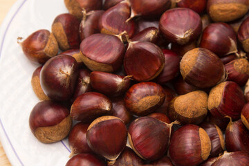 plate full of chestnuts on wood