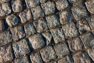 Abstract background of old pavement close-up in sunrise rays