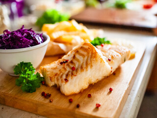 Fish dish - fried fish fillet with french fries and vegetables