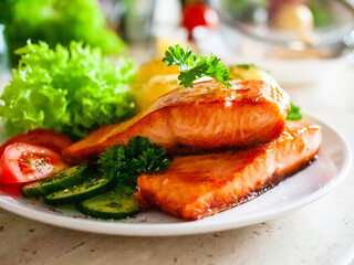 Fried salmon, French fries and vegetables