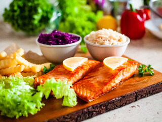 Fried salmon, French fries and vegetables