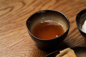 Homemade pancakes with jam, honey and sour cream bowls, close-up