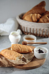 Tasty breakfast with French baguette and croissants with honey. Fresh bakery. Still life
