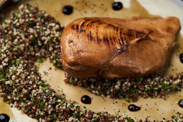 Roasted chicken breast on plate on wooden table background