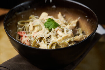 Spinach pasta salad with cheese, paprika, chicken, parsley.