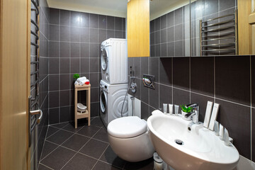 Sink, toilet, washing machine. Modern interior of bathroom.