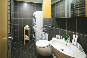 Sink, toilet, washing machine. Modern interior of bathroom.