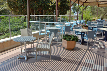 Fototapeta na wymiar Summer cafe on the terrace in the open air without people