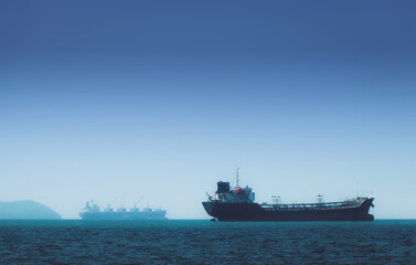 Logistics and transportation of International Container Cargo ship in the ocean at Sunshine sky,...