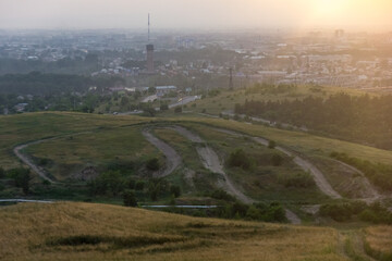 Khakassiya region, travel, landscape and nature of Russia. Yellow golden orange dramatic dawn at dawn or dusk over endless fields, hills, meadows. The sun rises in the morning above the horizon