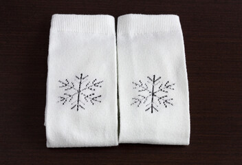 Warm knitted socks on wooden table