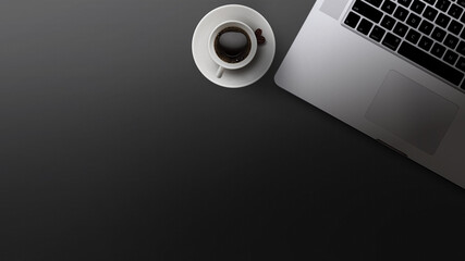 table top view with laptop and coffee on a black background, the table is covered with cloth