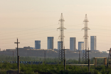 Production complex, power wires, pipes with smoke.