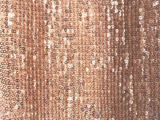 Vertical golden sparkling photo background. Sequined fabric texture.