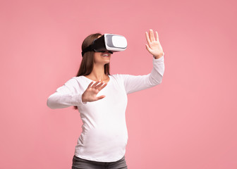 Excited Pregnant Woman Using Virtual Reality Headset Standing, Studio Shot