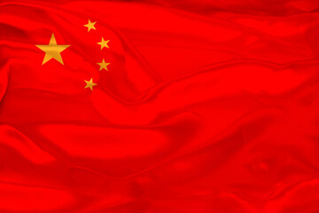 photo of the beautiful colored national flag of the modern state of China on textural fabric, concept of tourism, economics and politics, closeup, economy and state policy