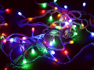 Fototapeta na wymiar Colorful bright Christmas garland with green, red and blue lights.